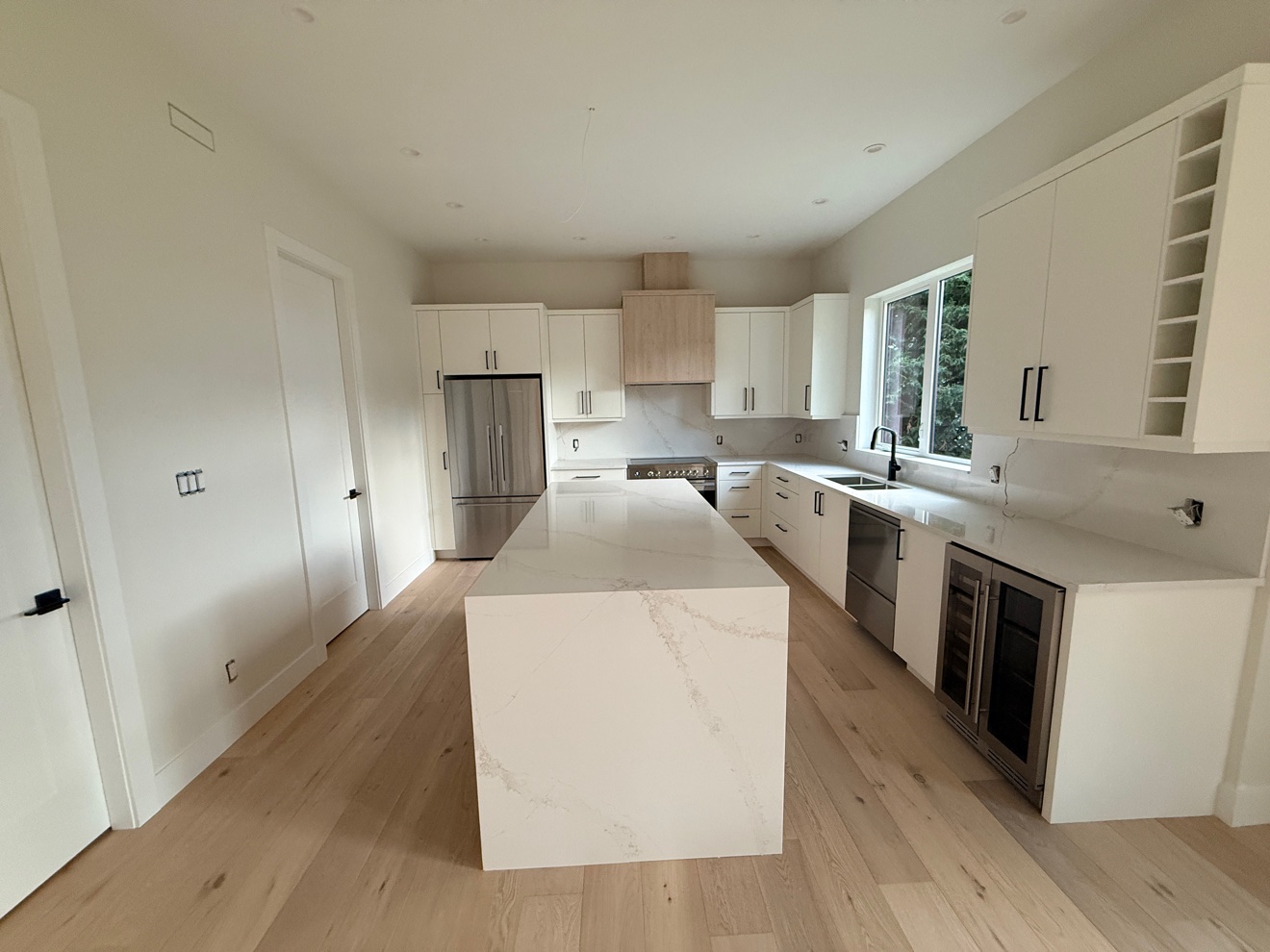 Kitchen with white island after a clean