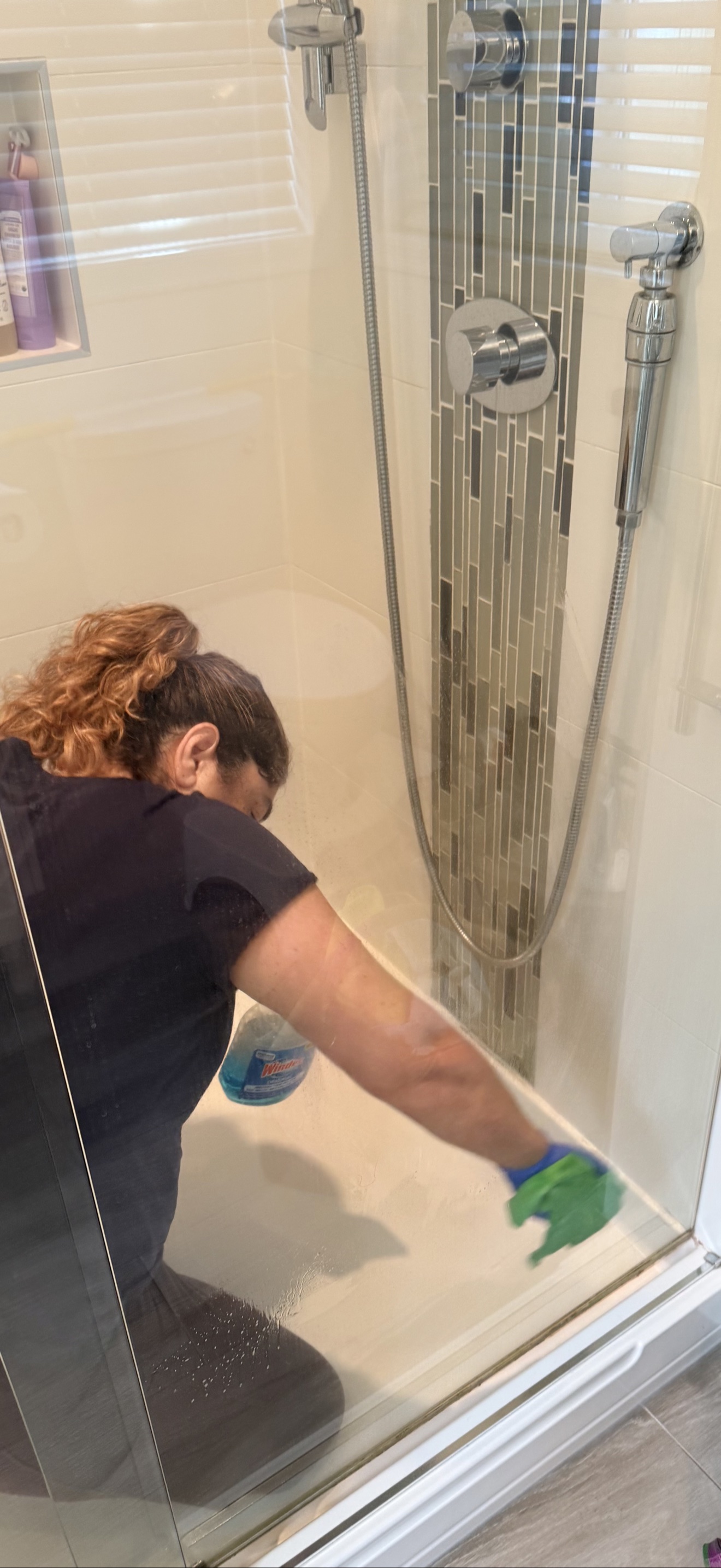 Cleaning shower glass by hand