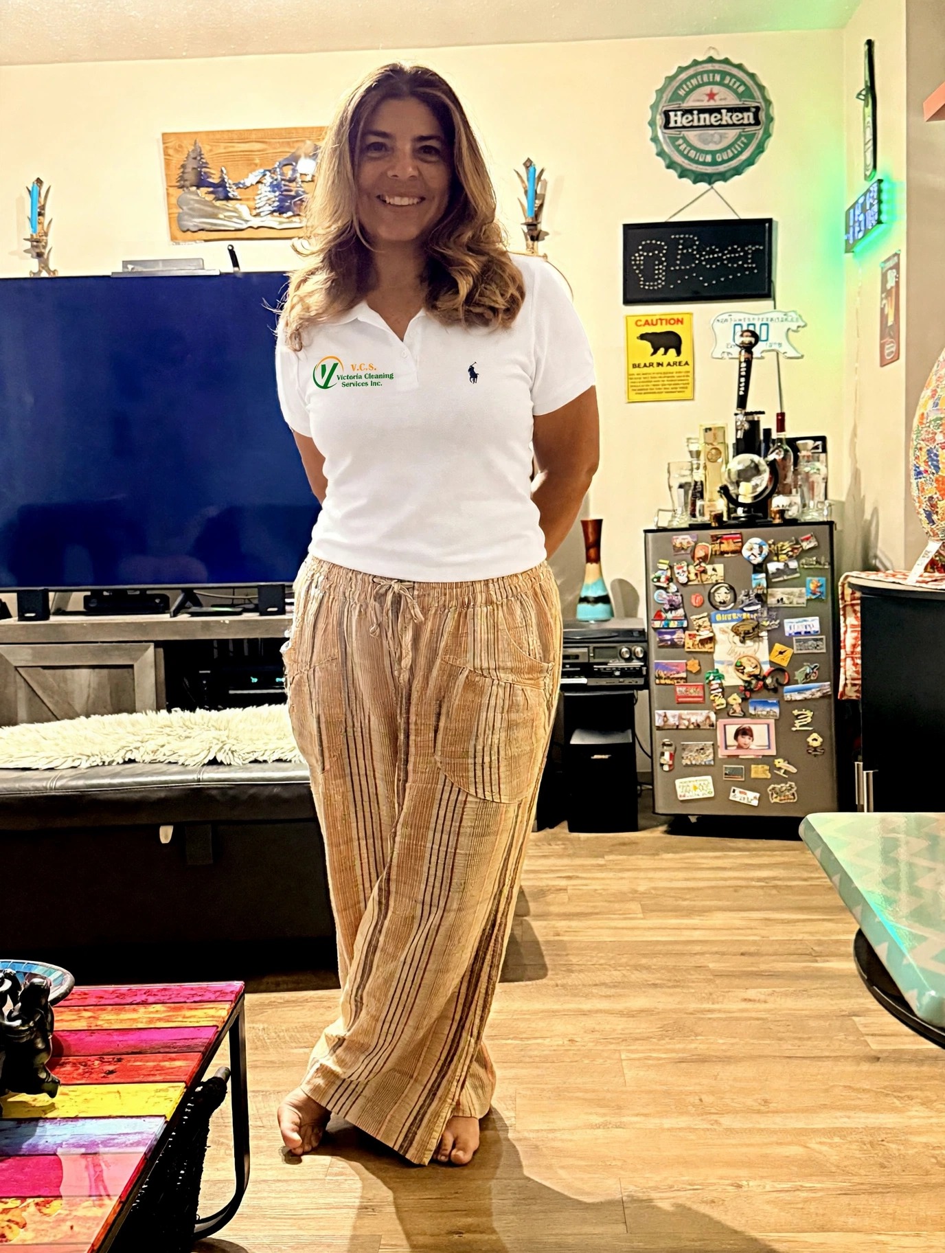 Team member smiling in a white VCS polo