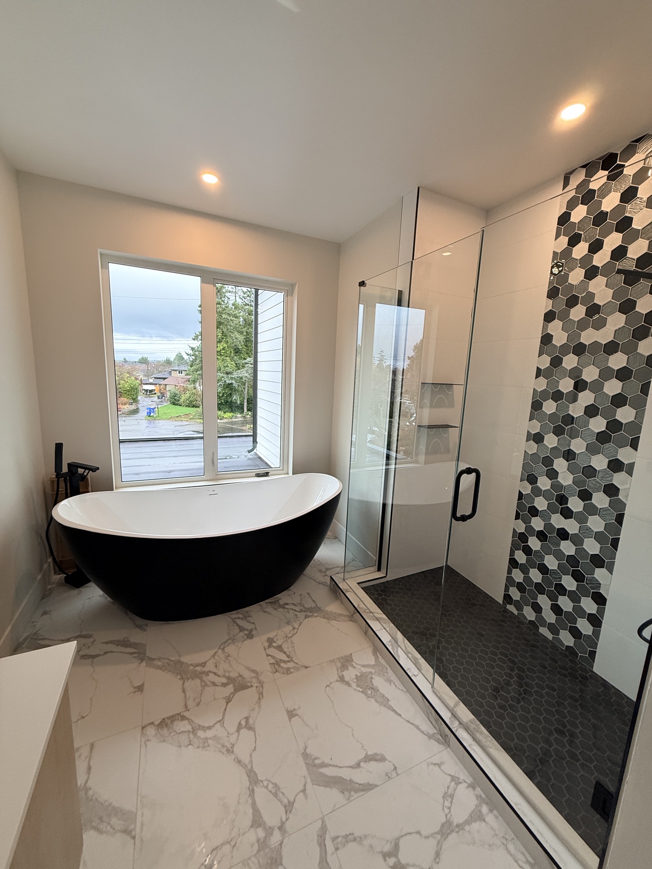 Bathroom with a black freestanding tub after a deep clean