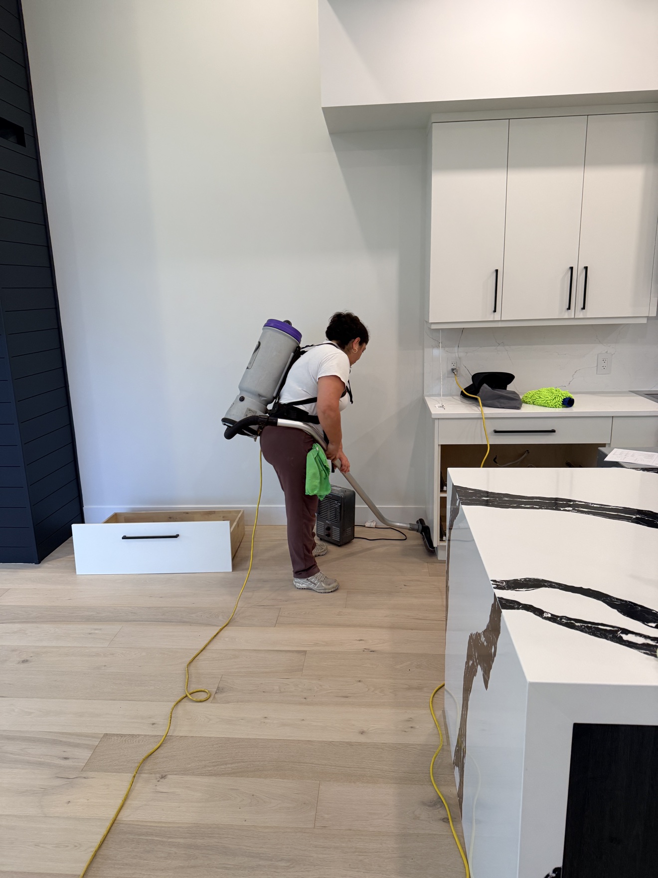 Vacuuming a kitchen floor